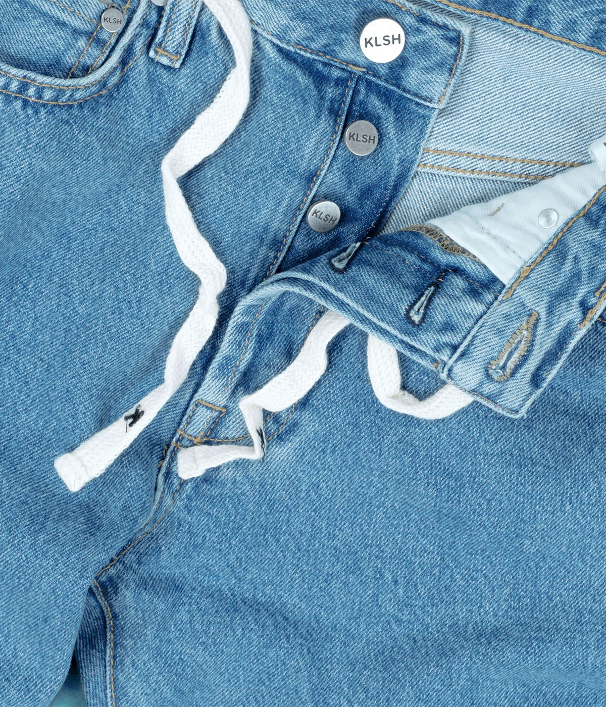 Close-up of blue denim jacket with white trim and KLSH branding.slider_item_fRRghB
