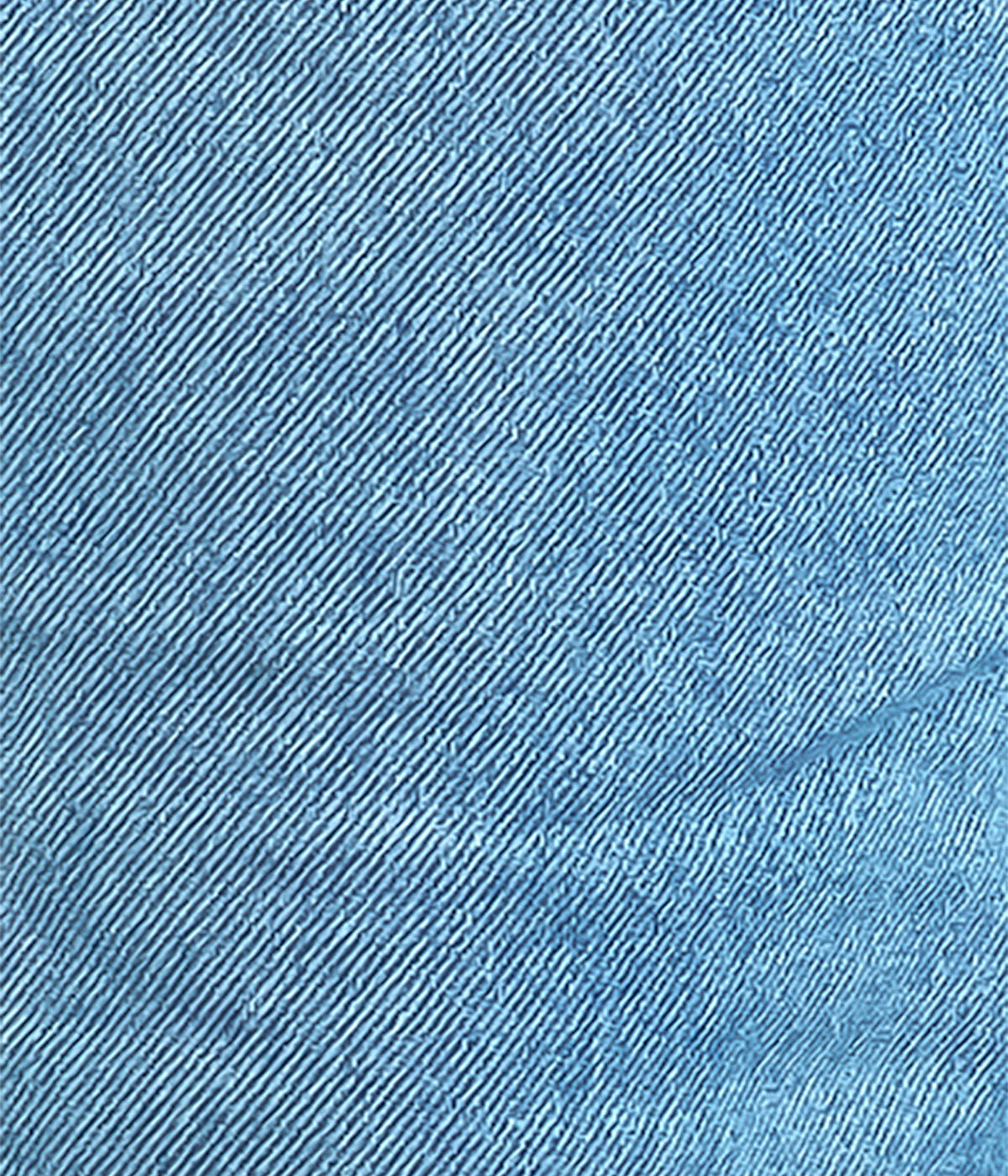 Close-up of faded blue denim fabric texture