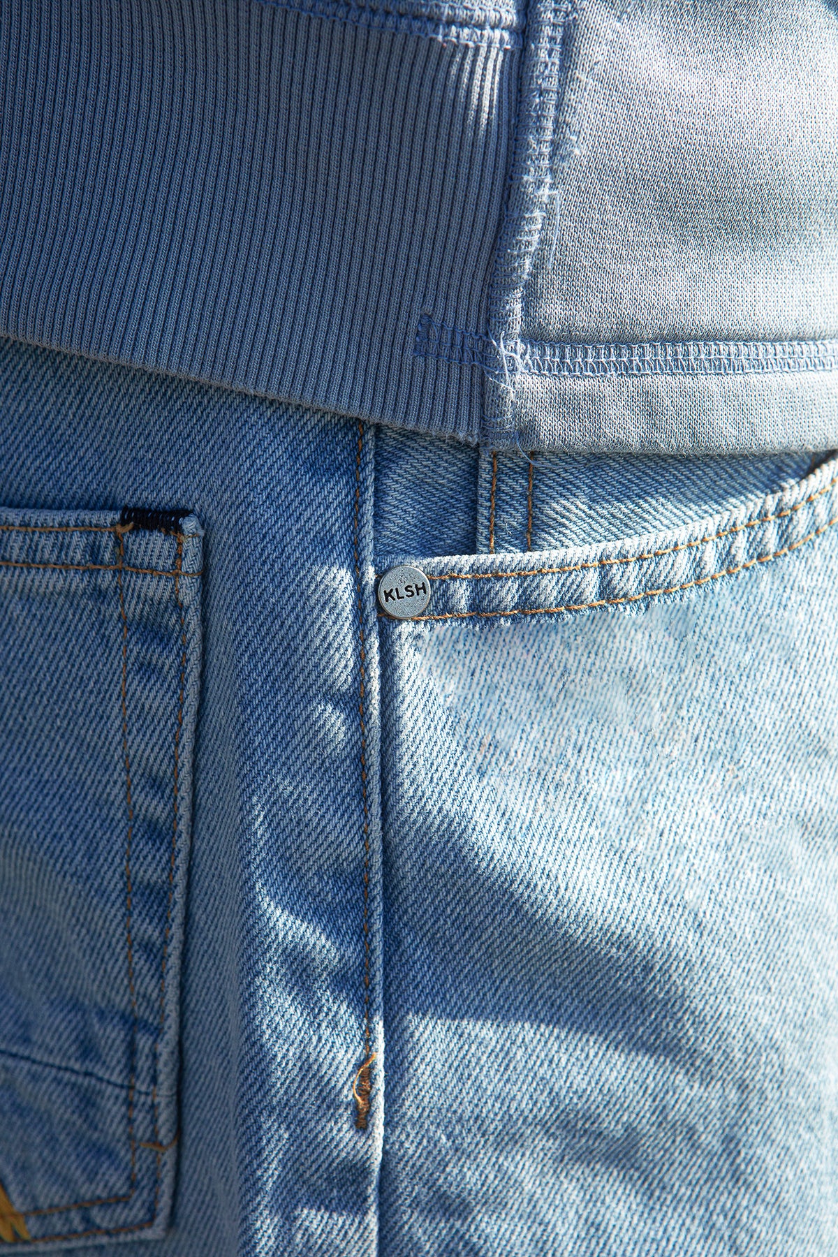 Close-up of blue denim fabric with a brand label.