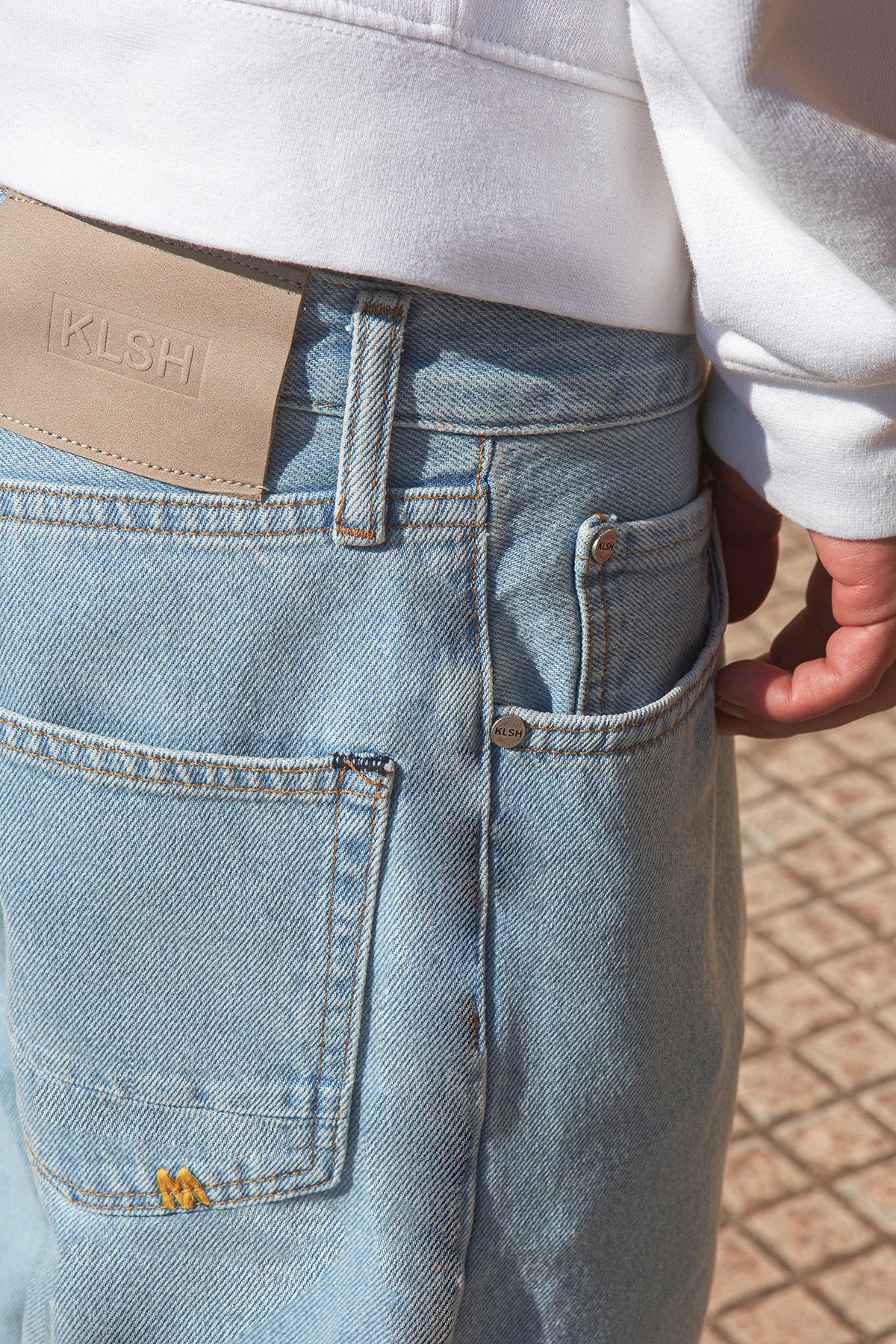 Light blue jeans with a visible brand logo on a blurred background