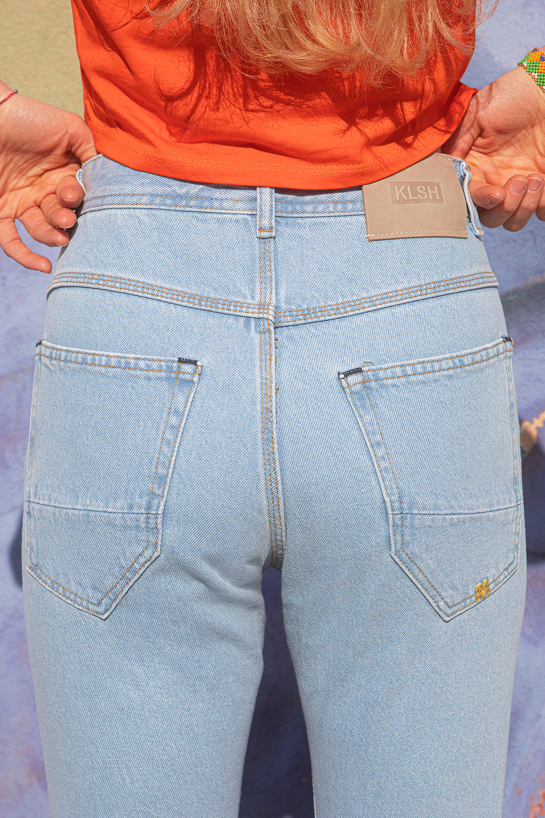 KLSH MORIS slim-fit jeans worn by a person against a textured wall.